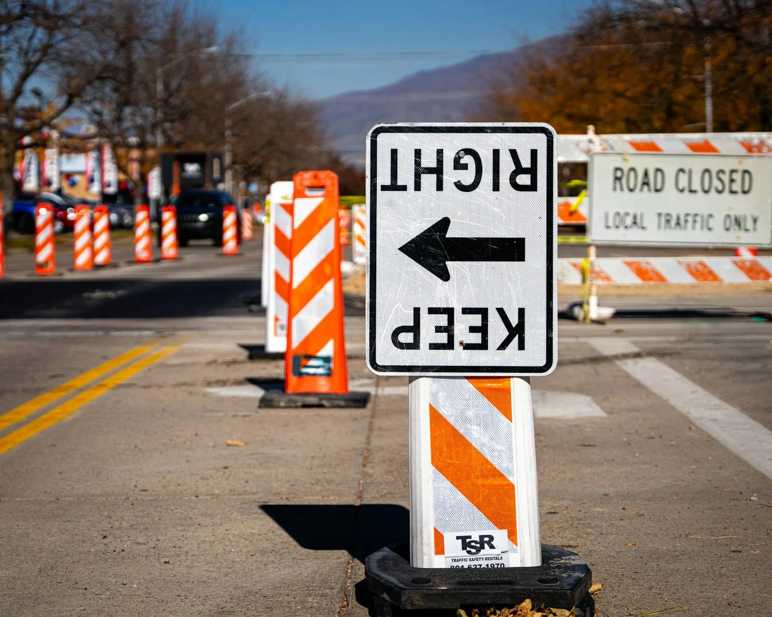 Construction zone in Bountiful, UT featuring traffic signs and barriers. Daytime setting.
